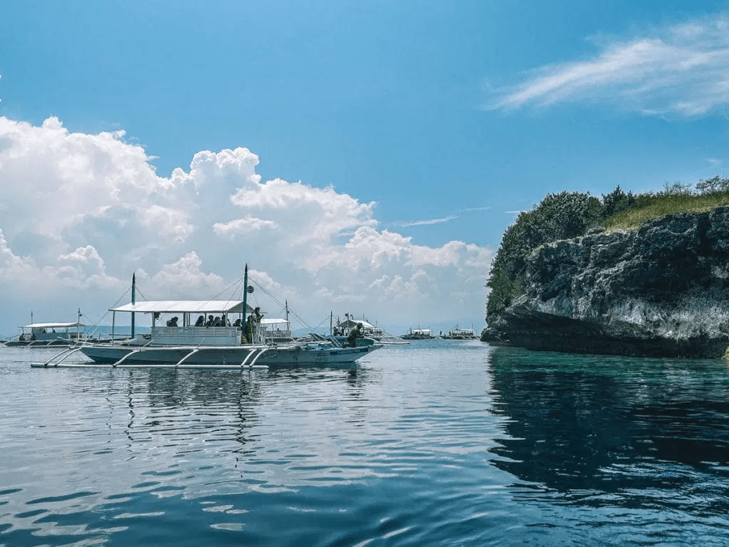 Boat on calm water in Moalboal, Cebu near popular snorkeling and island-hopping areas